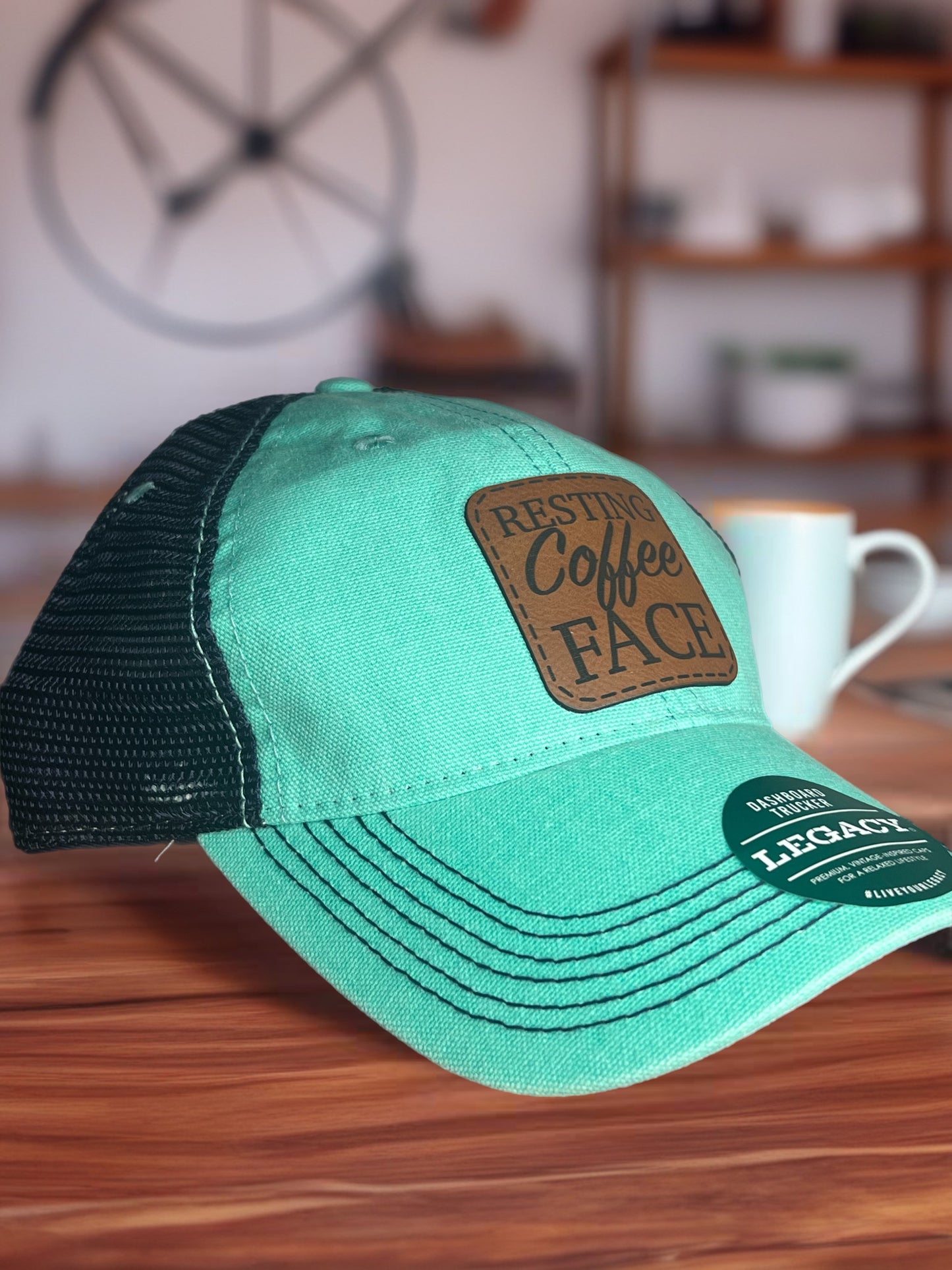 Legacy teal/navy hat (resting coffee face)
