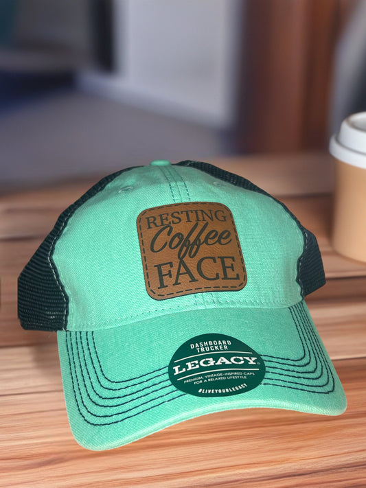 Legacy teal/navy hat (resting coffee face)